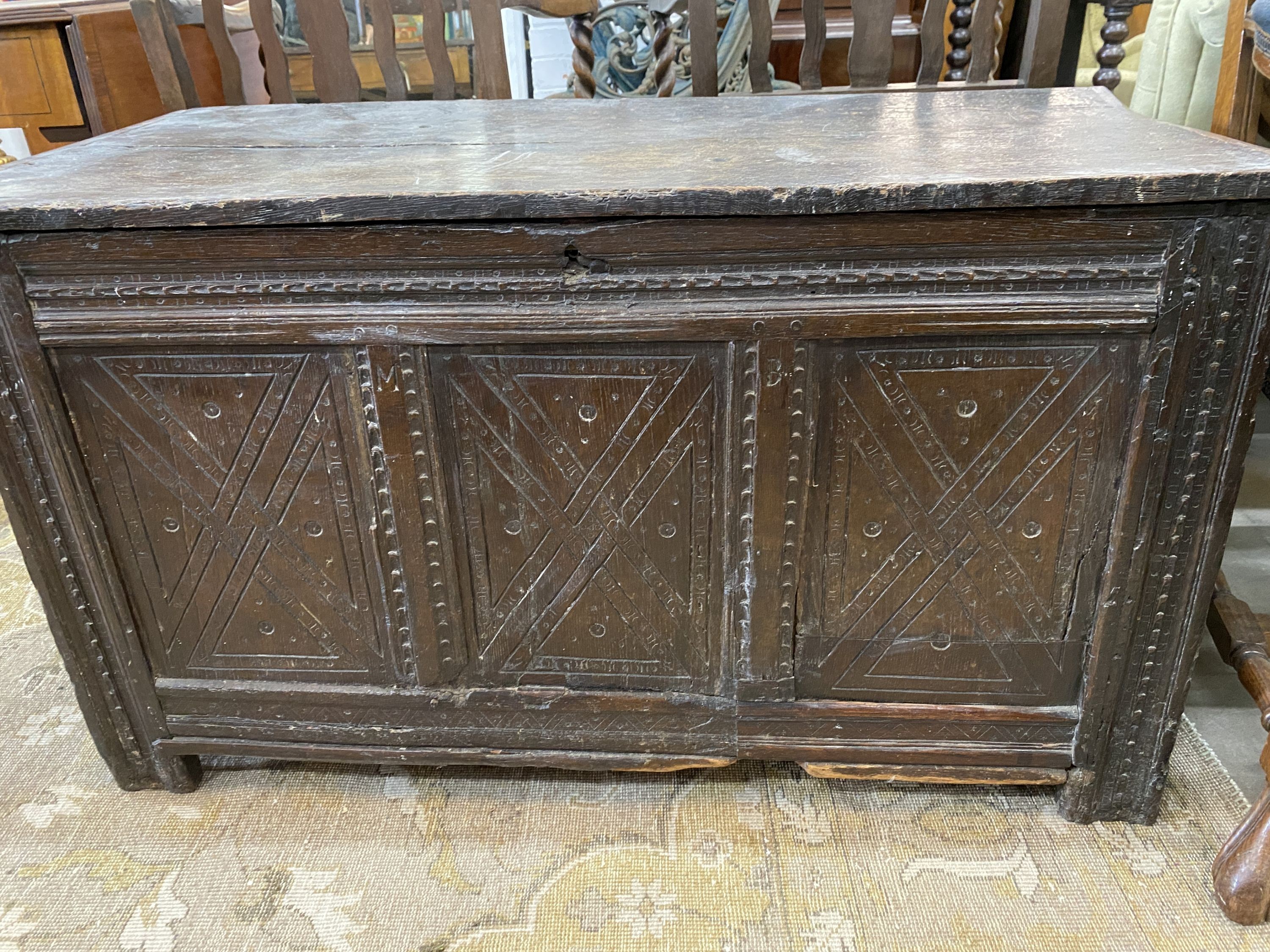 A 17th century carved oak coffer, length 110cm, depth 52cm, height 61cm